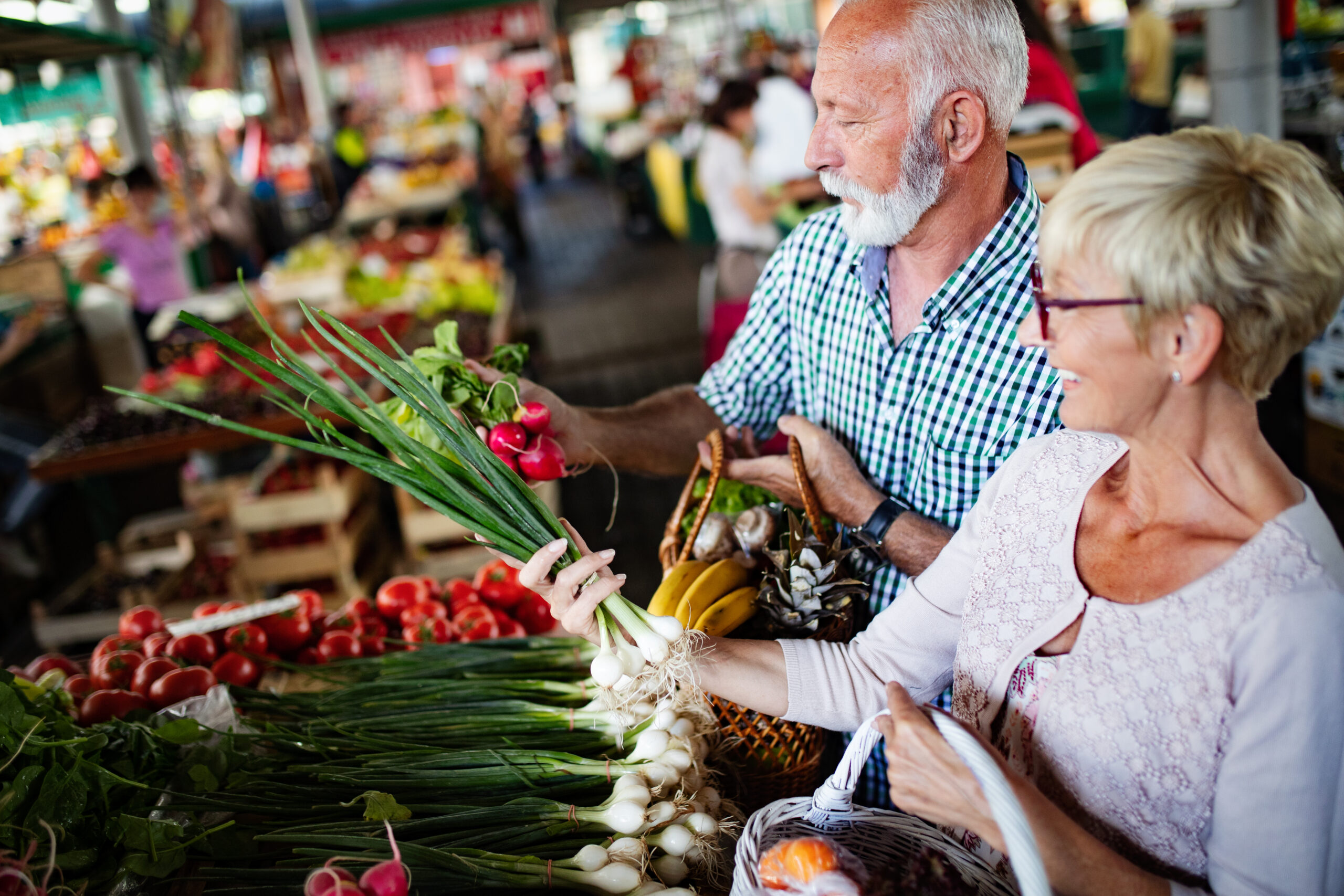 Beautiful senior couple choosing health products in the market